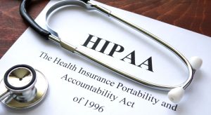 Stethoscope lying across a HIPAA document titled Health Insurance Portability and Accountability Act.