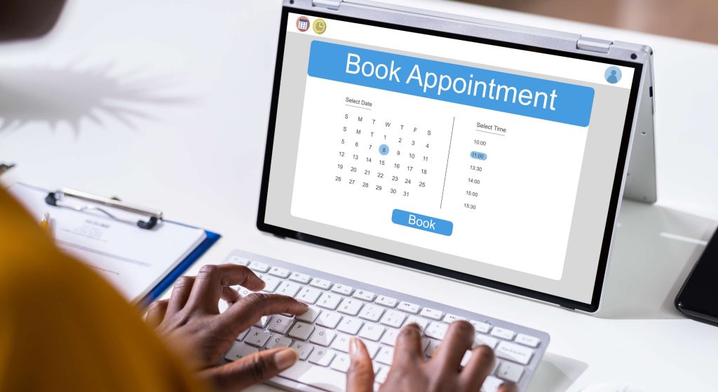 Laptop screen shows an online appointment booking form with a calendar and a 'Book' button, plus time slots on the side.
